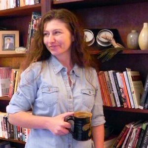 tara caimi holding mug in frong of shelf